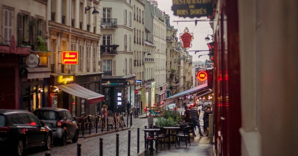 Quaint Parisian street on a rainy day with vintage buildings and cobblestone path.