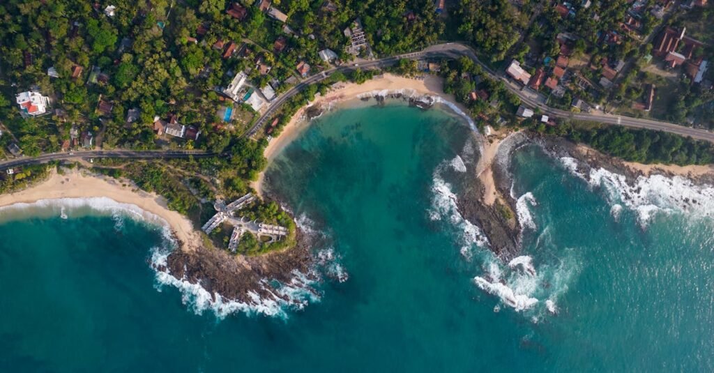 Stunning aerial view of Thangalla Beach, Sri Lanka, showcasing turquoise waters and lush greenery.