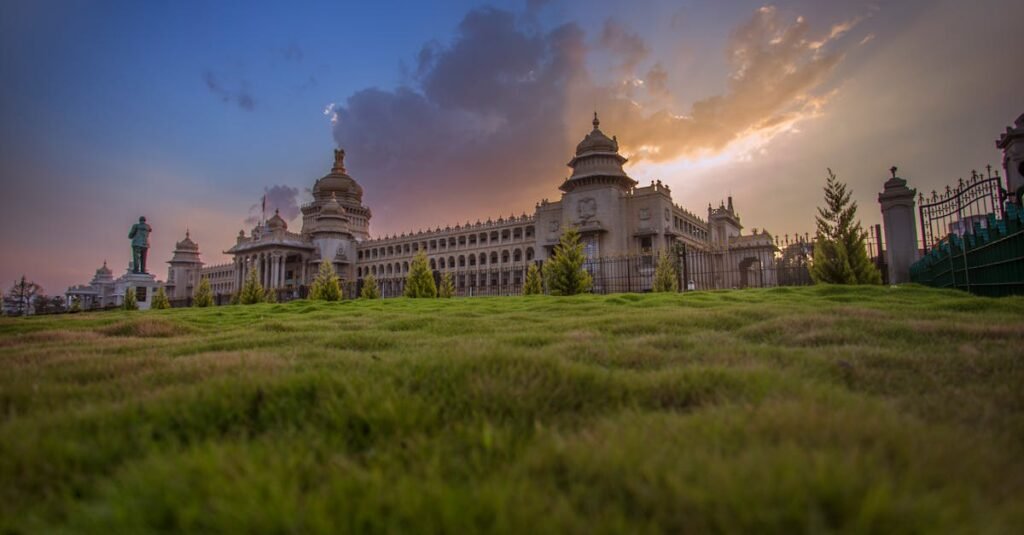 Capture of Vidhana Soudha in Bengaluru with a vibrant sunset sky, showcasing beautiful architecture.